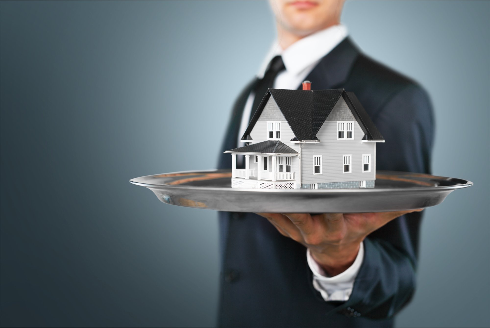 Businessman Holding House Model