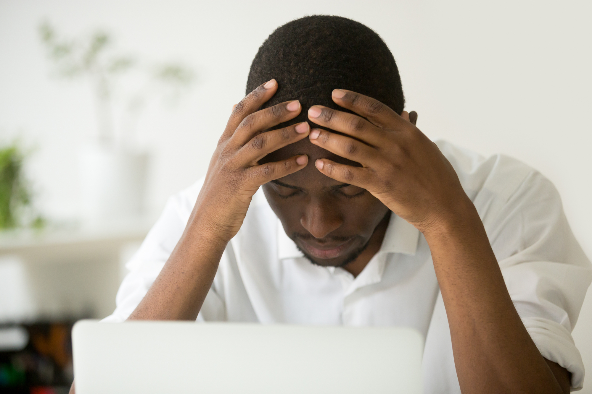 Frustrated african businessman feeling exhausted depressed