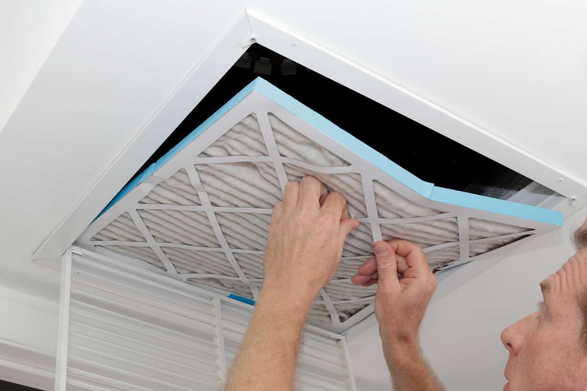 Man Removing Dirty Air Filter (R) (S)