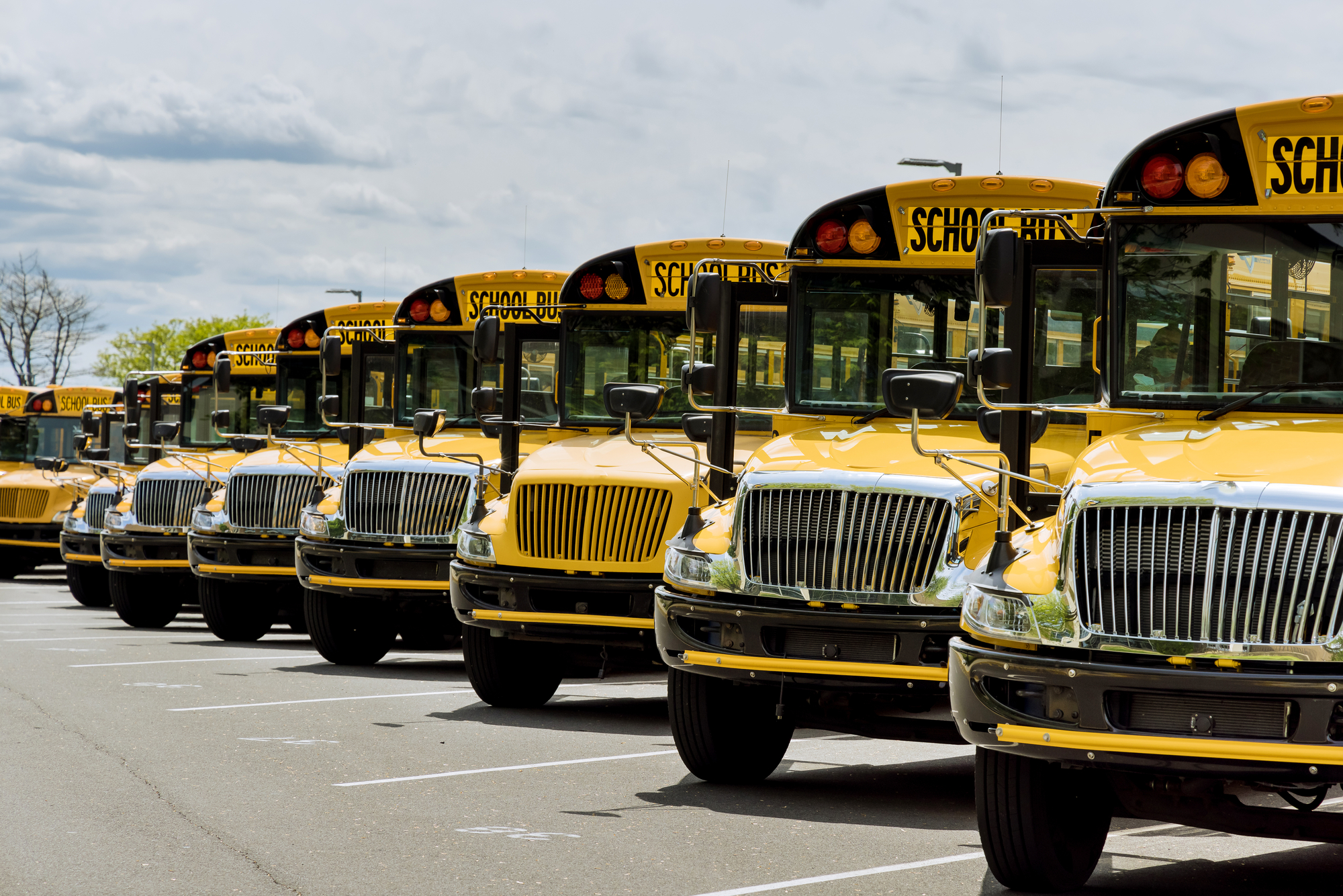 View the yellow school buses parked near the high school