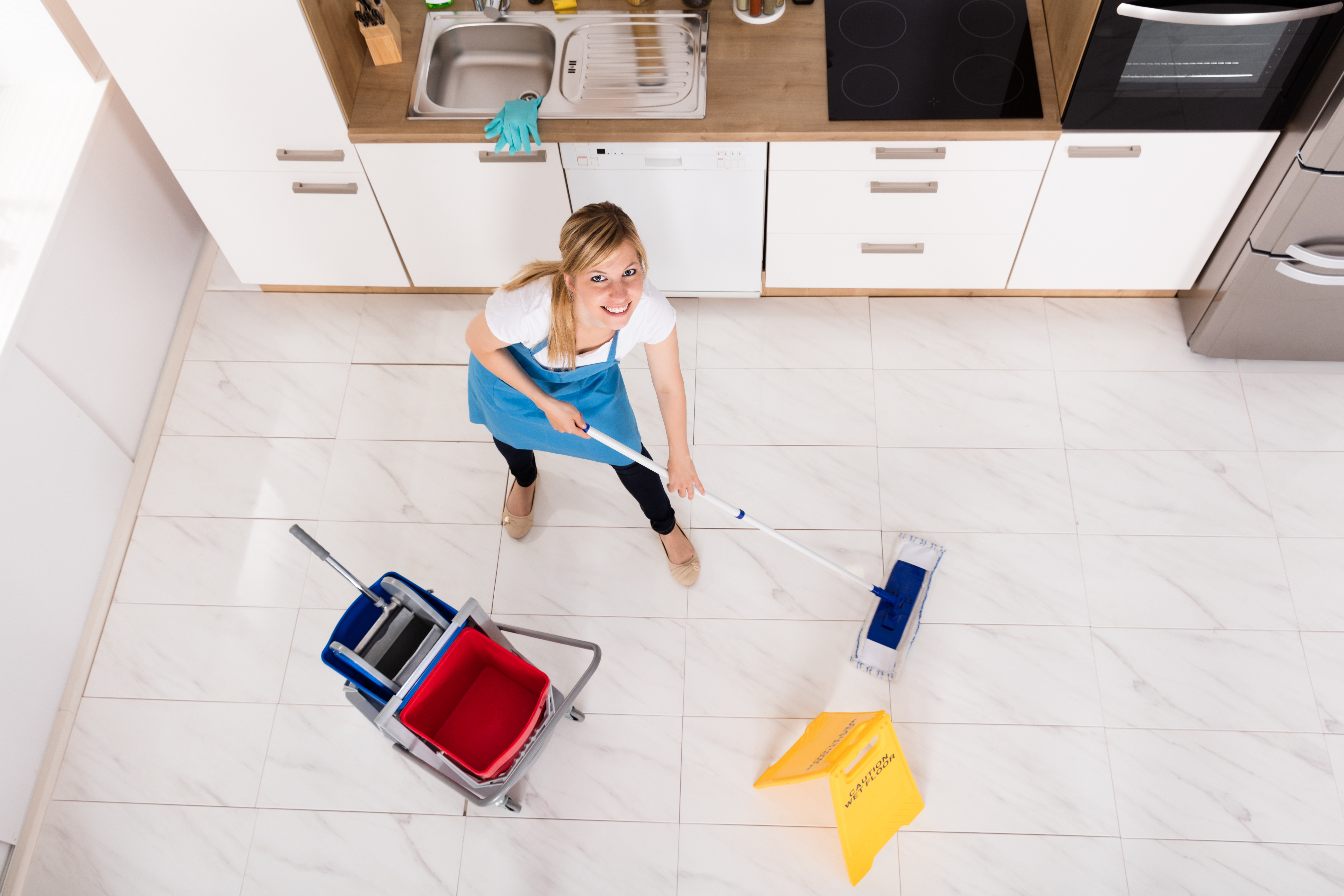 Woman Cleaning Kitchen Floor