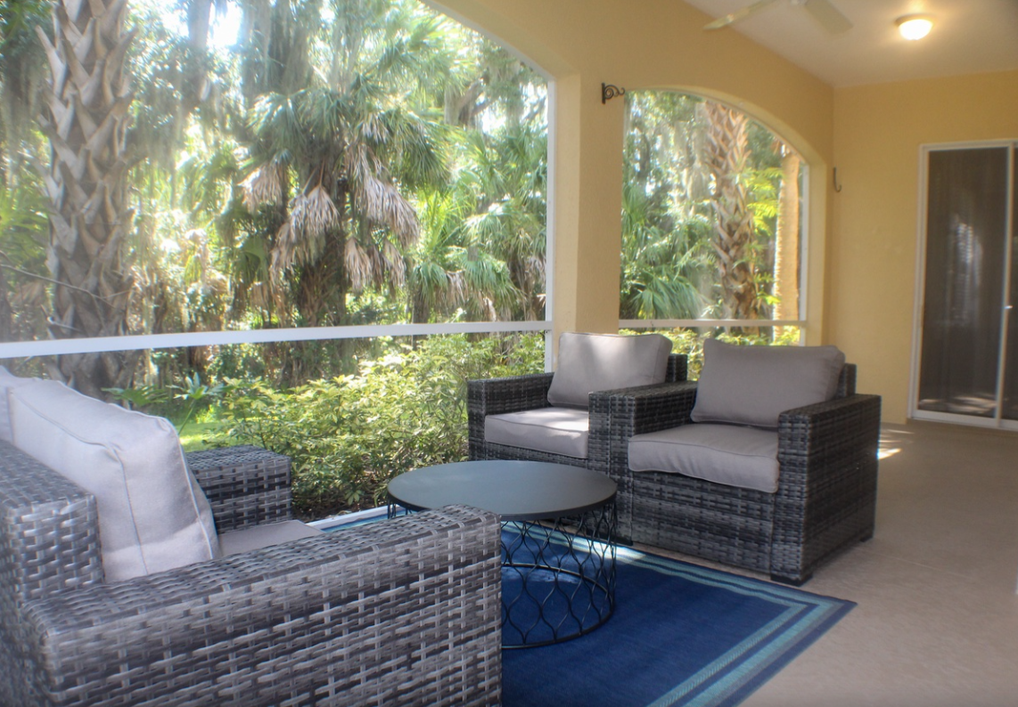 Beautiful Bradenton vacation rental property with palm trees and chairs
