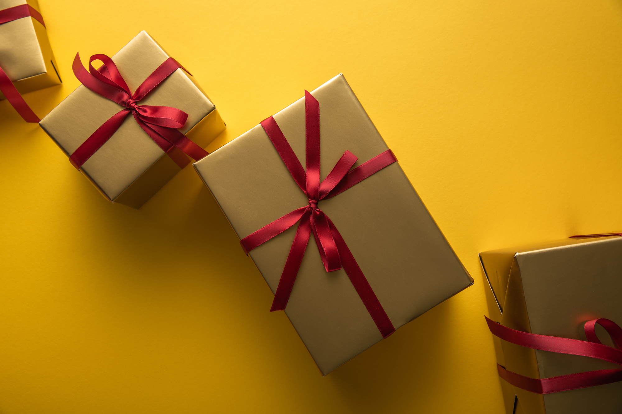 golden gift boxes with red ribbons